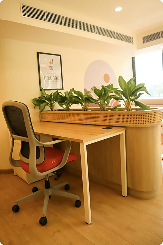 A private dedicated desk with plants at Worksiva Gurugram